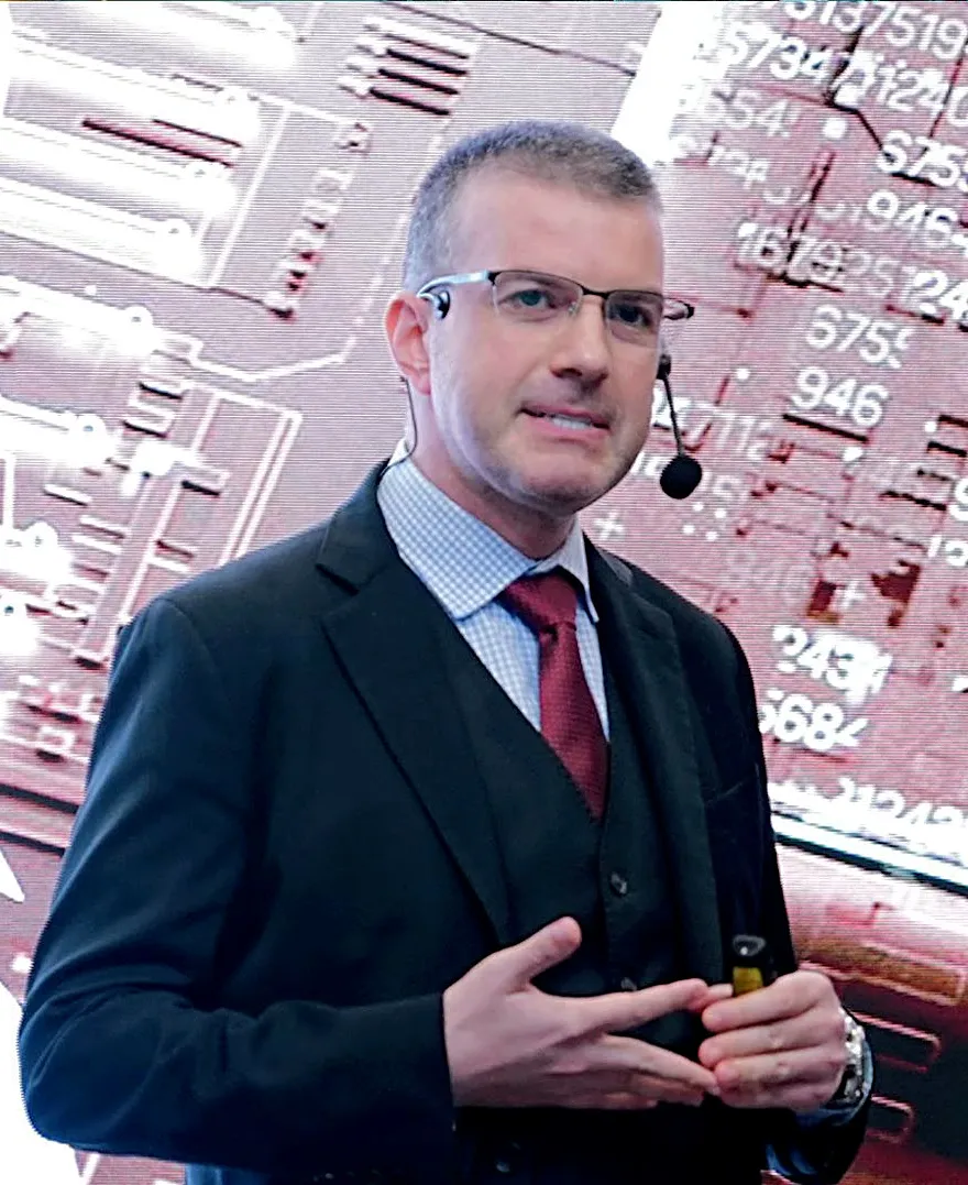 Dr. Tim Nedyalkov speaking with a headset microphone at a technology conference in Riyadh